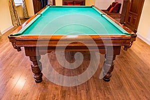 Billiard table with green cloth