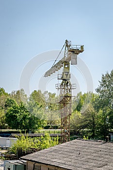 Large yellow construction crane with a hook.