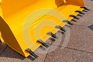 A large yellow construction excavator on a construction site. A new quarry bulldozer for the development of quarries at the