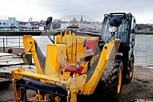 Large yellow JCB style vehicle for construction lifting and excavating plant machine