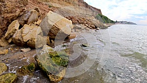 Large yellow sand stones boulders rocks on sandy beach of the sea shore. Natural