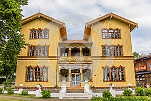 Large yellow wooden mansion in Juodkrante
