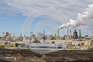 Huge oil refinery plant with smoked pipes