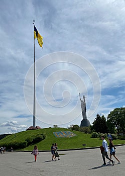 The largest flag of Ukraine and the famous Motherland Monument in Kyiv, Ukraine