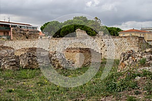 Larino, Campobasso, Roman archaeological site on the modern building background, on a sunny day photo