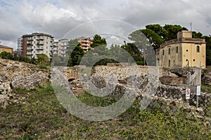 Larino, Campobasso, Roman archaeological site on the modern building background, on a sunny day photo