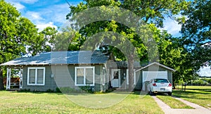 Modern rural life in Texas. Ancient wooden house and lawn