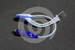 Laryngeal mask airway for emergency medical help on a black background.