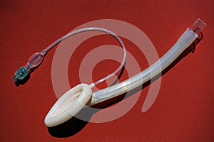 Laryngeal mask airway for emergency medical help on a red background