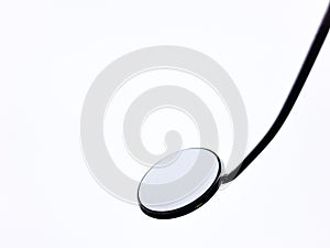 Laryngeal mirror on light background isolated