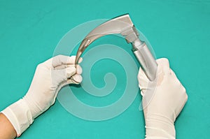 Laryngoscope in hand of doctor photo