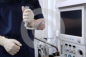 Laryngoscope in the hands of an anesthesiologist.Tracheal intubation. Preparation of equipment for surgery under general