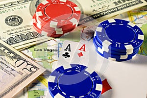 Las Vegas on map with money, poker chips and pair of aces playing cards