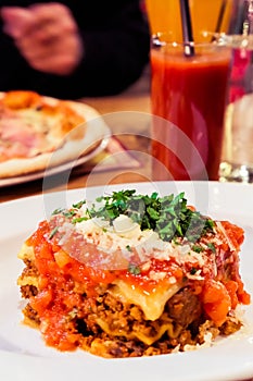 Lasagna bolognese plate, traditional recipe with tomato sauce, cheese and meat