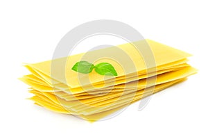 Lasagna pasta with basil herb leaf sprig isolated