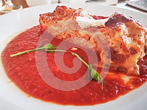 Lasagna in Tomato Sauce. Tasty delicious italian dish lasagna with tomato sauce and cream cheese with green salat. Food, tasty