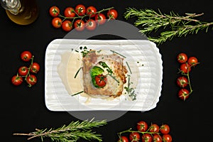 Lasagne with basil leafs in white dish. Classic italian dish. Tomatoes and rosemary on the table. Italian cuisine