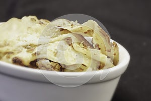 Lasagne served in white bowl