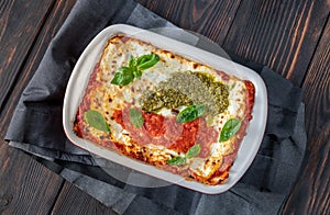 Lasagne topped with tomato sauce and pesto