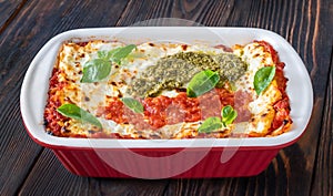 Lasagne topped with tomato sauce and pesto