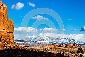 LaSal Mountain Range in snowstorm viewed from Arches National Park, Utah photo