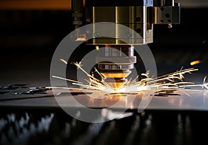 Laser cutting machine creating sparks while processing metal sheet