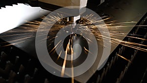 A laser cutting machine cuts a metal plate. High-tech sheet metal production process using a laser cutting machine. The