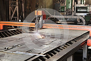 Laser cutting of metal. Automated machine for precise metal cutting. Plasma cuts steel. The machine is a robot.
