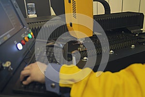 Laser cutting and the operator at the control panel