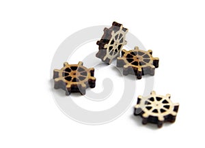 Laser cutting wooden gears on a white background