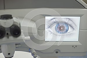 Laser eye surgery. Close-up workplace of an ophthalmologist surgeon, monitor with a graphic image of the eye, microskim for