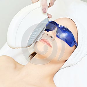 Laser facial hair removal. Cosmetology ipl device. Woman body in clinic. Medical beauty girl. Acne salon treatment tool