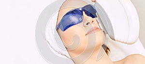 Laser facial hair removal. Cosmetology ipl device. Woman body in clinic. Medical beauty girl. Acne salon treatment tool