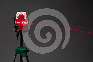 Laser level tool red light beam, grey background