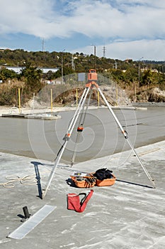 Laser level on a tripod for forming a concrete slab