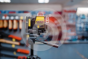 Laser level on tripod in tool store, nobody