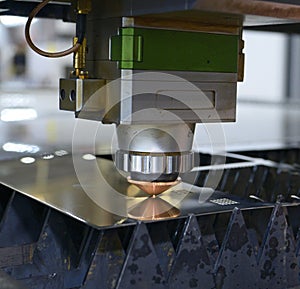 Laser machine cutting metal sheet, sparks coming