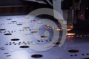 Laser machine cutting of sheet metal.