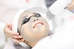 Laser Machine.Young woman receiving laser treatment.Skin Care.Young Woman Receiving Facial Beauty Treatment, Removing Pigmentation