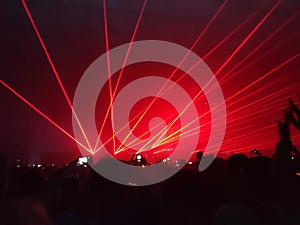 Laser show nightlife club stage with party people crowd. entertainment with audience silhouettes in nightclub event