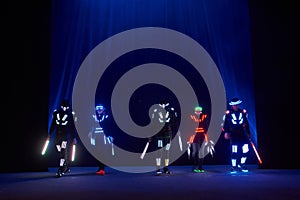 Laser show performance, dancers in led suits with LED lamp, very beautiful night club performance, party