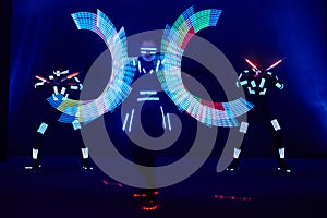 Laser show performance, dancers in led suits with LED lamp, very beautiful night club performance, party