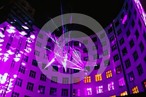 Laser show on wall of multistory building