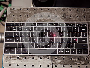 Laser system engraving cyrillic letters on bluetooth keyboard. Keyboard laser engraving.