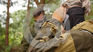 Laser tag game. Men in camouflage with guns and playing airsoft. Close up shot.