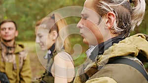 Laser tag game. Soldiers communicate among themselves. Men in camouflage with guns and playing airsoft. Close up shot.