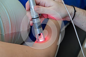 Laser therapy in hand used to treat pain.