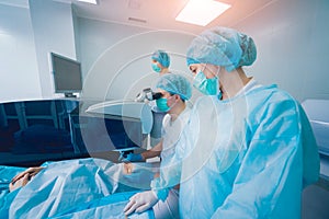 Laser vision correction. A patient and team of surgeons in the operating room