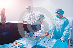 Laser vision correction. A patient and team of surgeons in the operating room