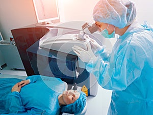 Laser vision correction. A patient and team of surgeons in the operating room